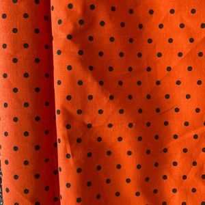 orange with black polka dot fabric